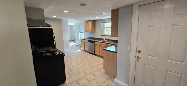 Kitchen looking toward living room - 103 S Main St Unit Basement