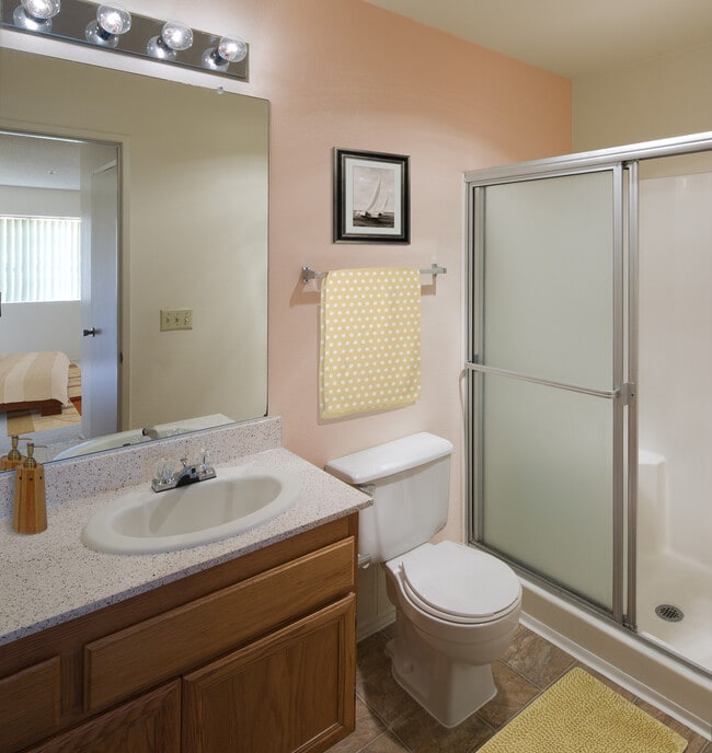 Classic Package bath with oak cabinetry, beige speckled laminate countertops, and tile flooring