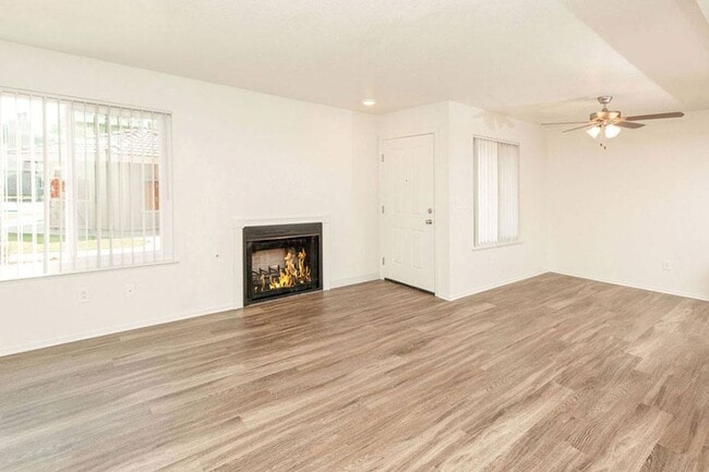 Living Room with Fireplace and Woodgrain Flooring