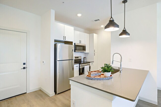 Quartz countertops, a deep stainless sink, and a full appliance suite are all included in the BH-A1 (L) floor plan's kitchen. Garrett Harvest Junction West, Longmont, CO. - Garrett Harvest Junction West