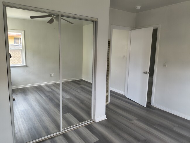 Double sliding glass mirror door closet with shelving inside - 2215 Carmona Ave