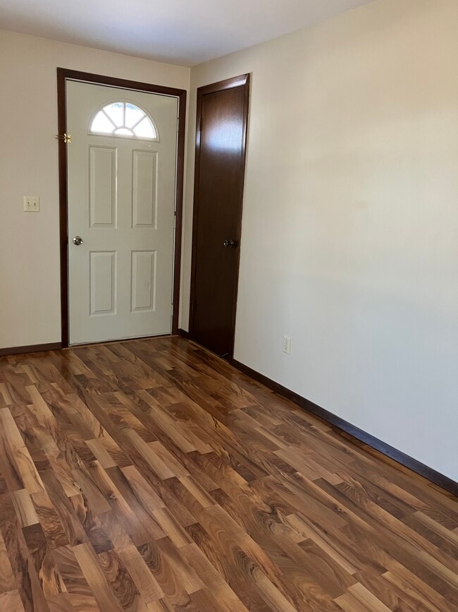 Front door into living room. Coat closet in the corner. - 1525 Commanche Ave