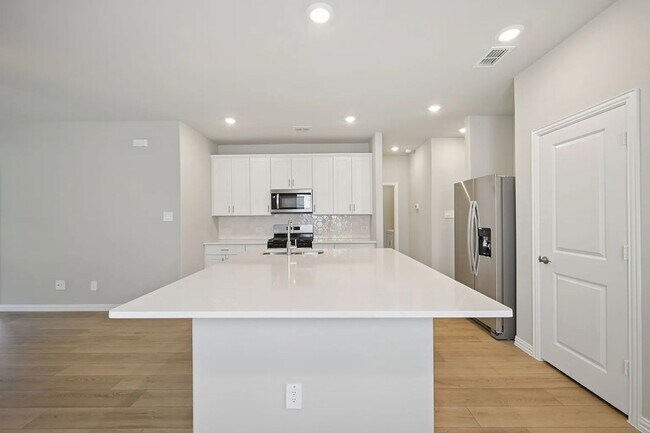 Photo - Stylish 3-bedroom home with modern kitchen, airy living spaces, vaulted primary suite, and elegan...