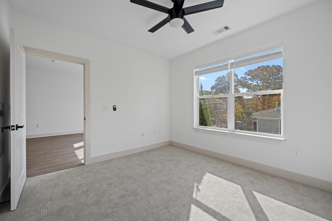 Natural light reaches every corner of this bedroom, desk spot included.