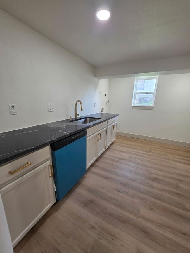 Photo - Studio Apartment with bathroom, kitchen & utility area on the lower level of property.