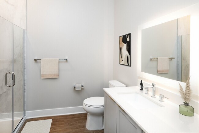 Signature Collection bath with white quartz countertop, backsplash, and hard surface flooring