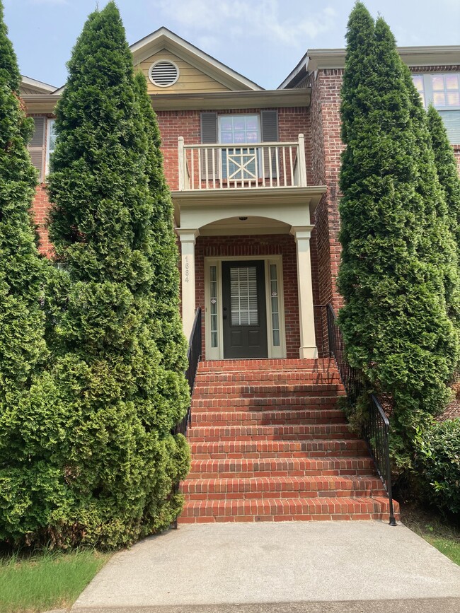 Front entrance, lots of greenery - 1684 Northgate Mill Dr Townhome