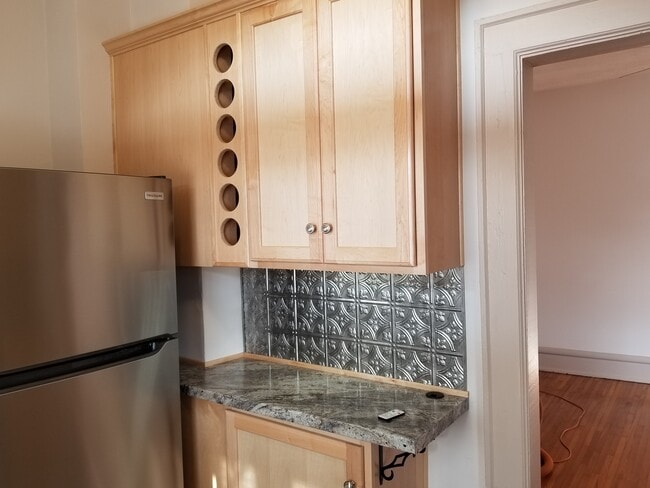 Soft Close Maple Cabinets with built-in wine rack. - 143 W 1st Ave Unit 143