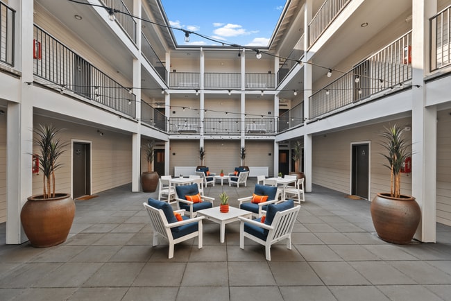 Relax and connect in our inviting courtyard lounge. - Alder Court Apartments