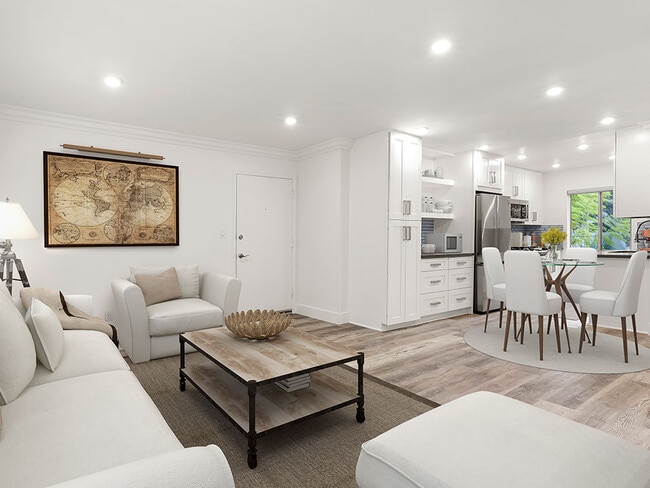 Hardwood floored living room with view of spacious kitchen. - The Glendon Building Apartments