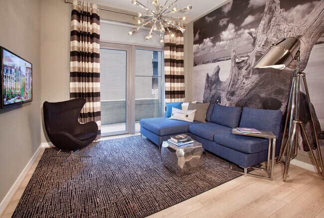 Living area with hard surface flooring and balcony
