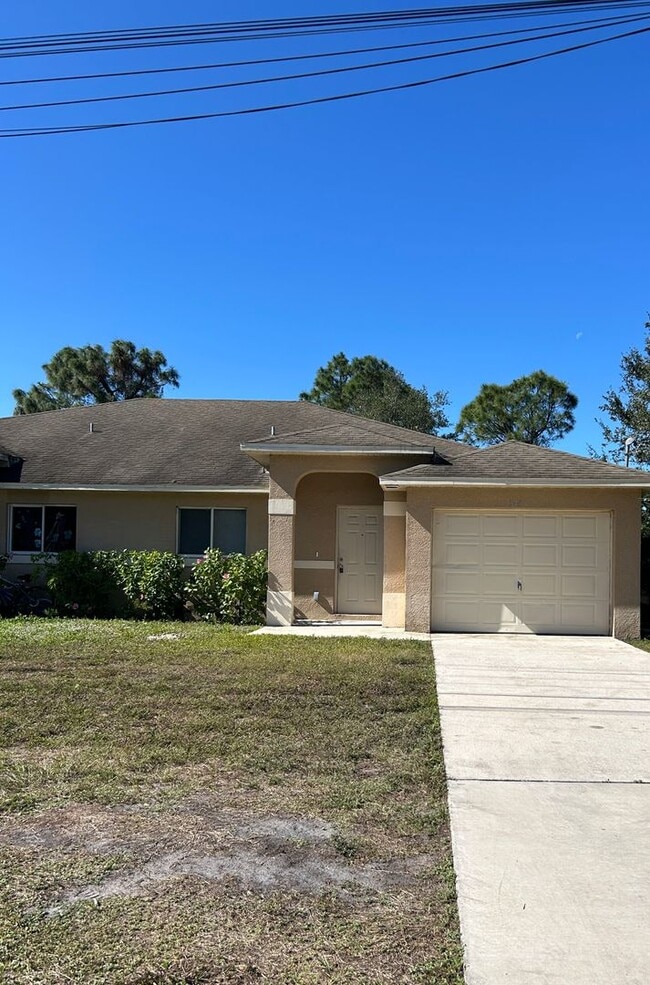 Photo - Charming 3BR/2BA Lehigh Acres Duplex with 1-Car Garage | Lawn Care & Salt Service Included