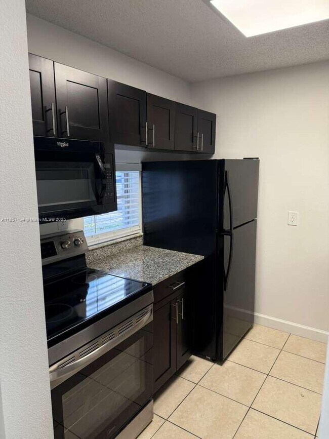 Building Photo - 8620 N Sherman Cir Unit 104 Rental