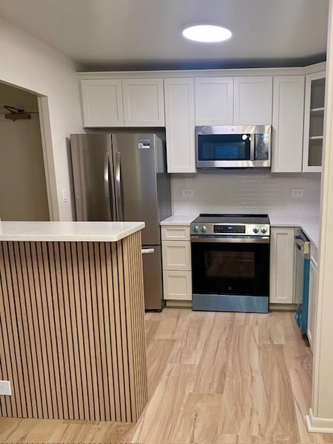 New stainless kitchen with quartz breakfast bar/island - 1850 N Clark St Unit 408