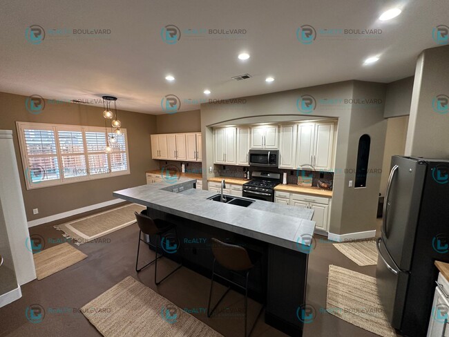 Photo - Open Kitchen, Expansive Living, and Covered Patio in Tranquil South Reno Near Trails, Parks & Sho...