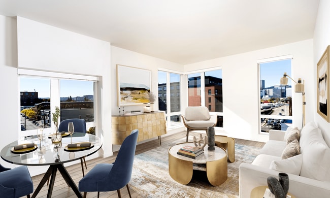 A light-filled living space at Modera Belmont, framed by expansive windows and city views, just steps from Belmont’s cafés, boutiques, and local favorites.