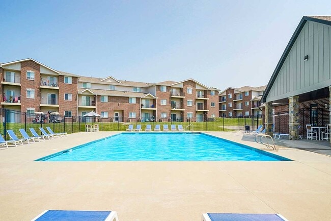 Take a dip and unwind in our luxurious pool area. - Northridge Heights Apartments
