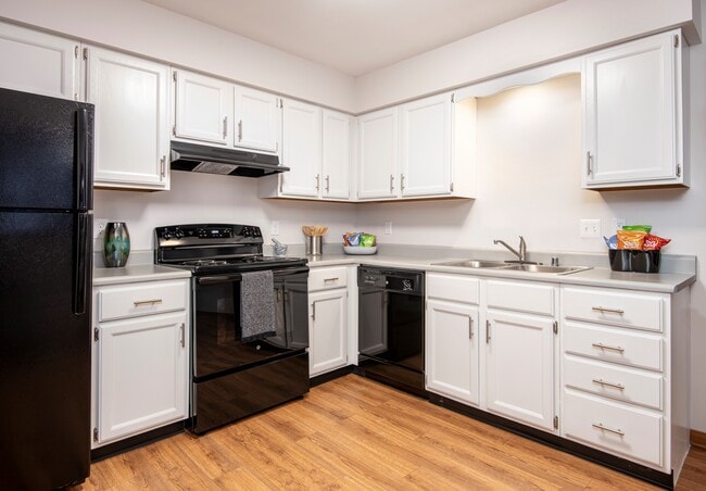 Kitchen with black appliance package - Preserve West Apartments