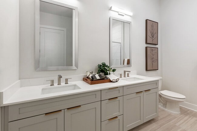 Stylish, spa-inspired bathrooms with framed mirrors and dual vanities available