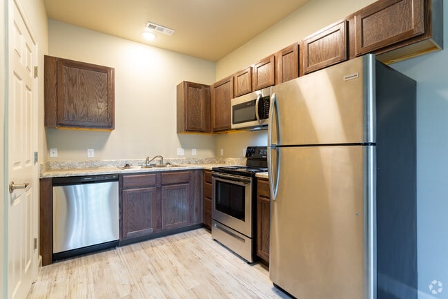 Kitchen with stainless steel appliances - Jordan Living Apartments