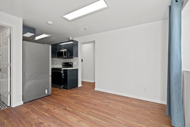 Open-concept renovated modern kitchen with all new stainless steel appliances - 411 124th St S Unit 411-B