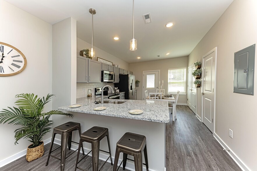 Kitchen with granite counters, stainless appliances, and modern cabinetry