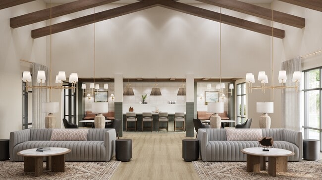 Spacious clubhouse with vaulted ceiling, pendant lights, lounge seating, and a communal kitchen with bar seating and décor - Oakwood Trails
