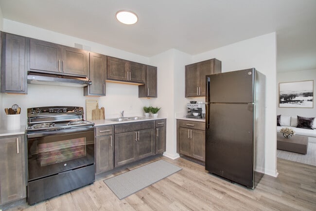 Modern Kitchen with Dark Cabinetry - Sunset Gardens Apartments