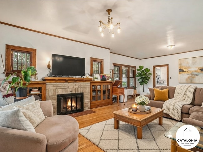 Large partly furnished livingroom comes with coaches, TV, tables, and window AC unit. - 2025 8th Ave Unit Whole House