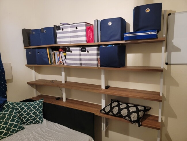 Built in shelving with storage bins and books