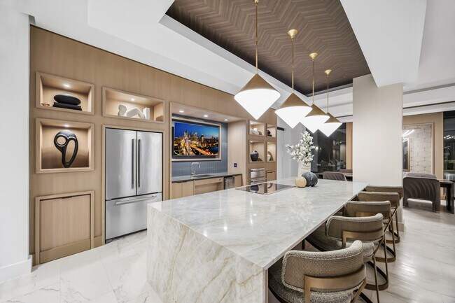 Entertaining kitchen and social lounge featuring a suite of premium appliances