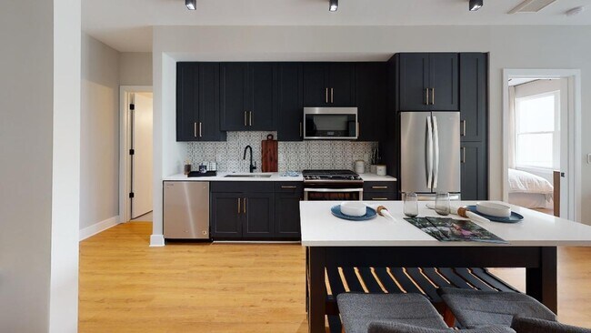 With chic quartz countertops and striking pendant lighting, your home is ideal for hosting.
