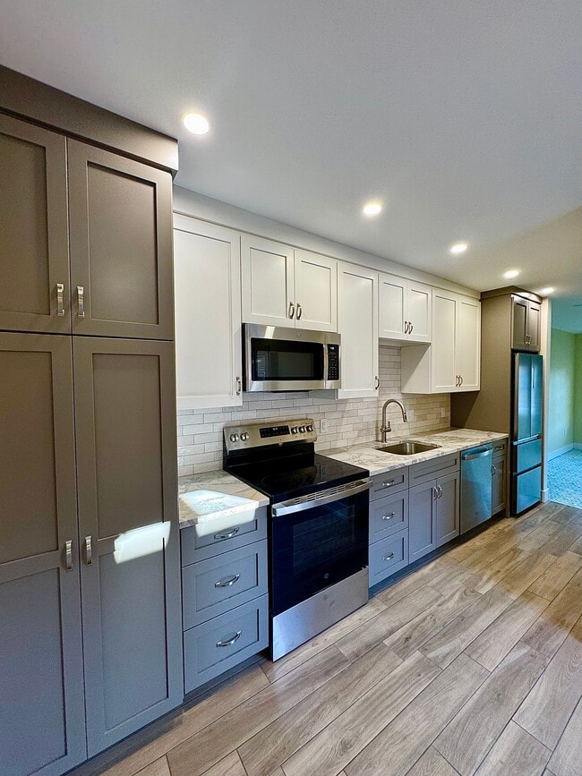 Beautiful galley style kitchen with custom cabinetry with marble countertops - 136 E King St Unit 2