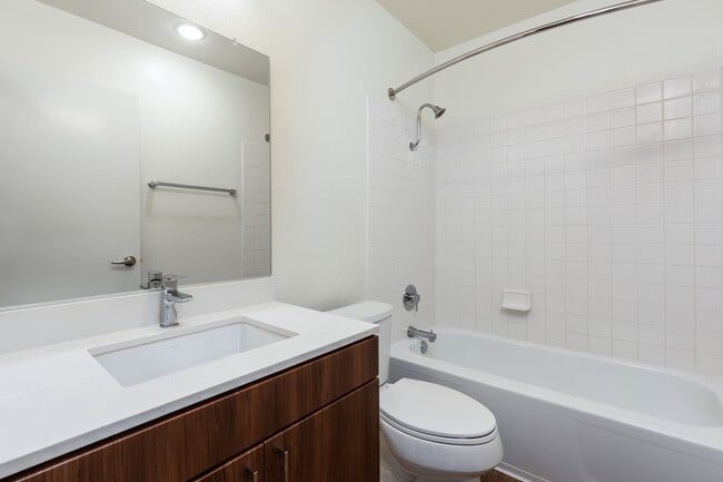 Renovated I bath with new cabinetry, quartz countertop, and hard surface flooring