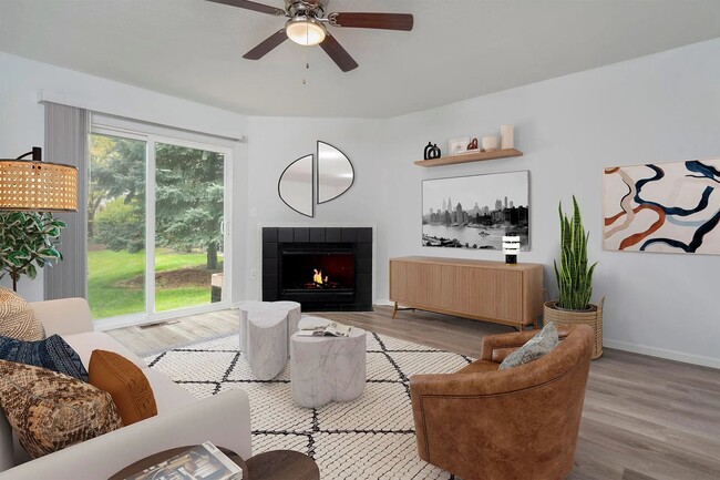 Premium Trentwood living room featuring wood-plank inspired flooring and a wood burning fireplace.