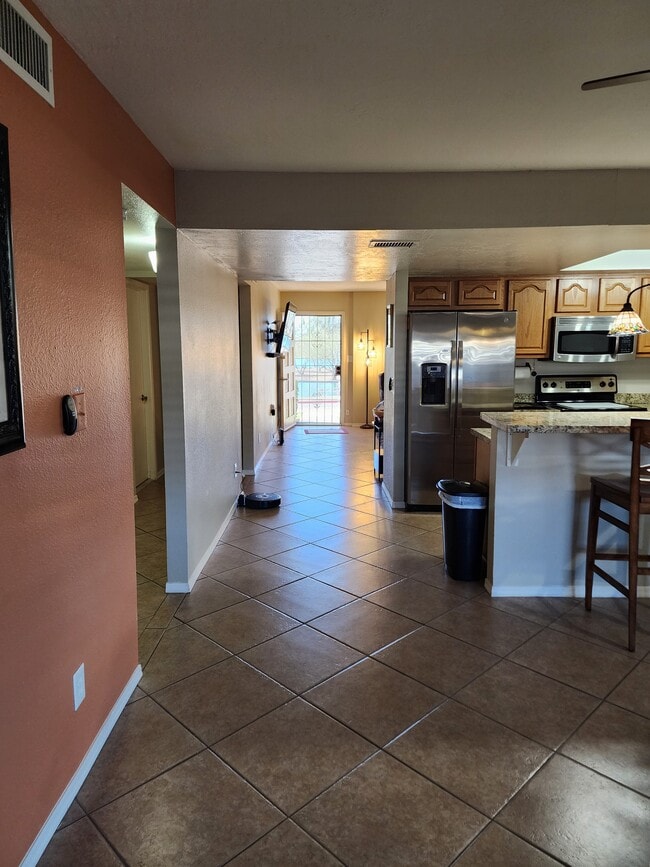 Furnished townhome flows through dining room and kitchen to living room and front door to park and l - 5050 N 81st St