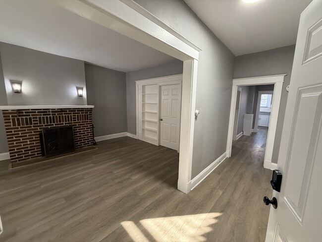 living room with adjacent hallway to dining room and kitchen - 606 N Woodington Rd Apartments Unit 1