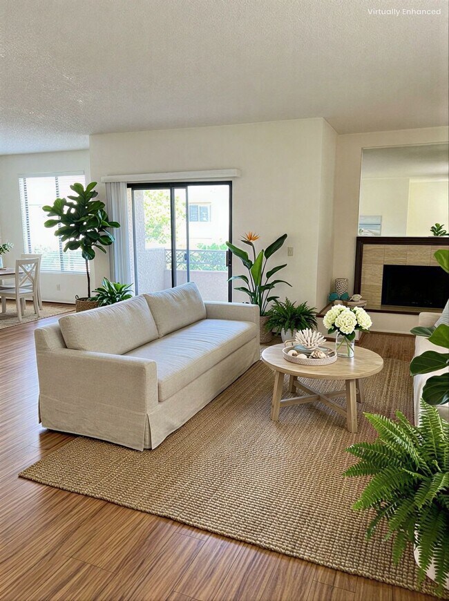 Living Room with Decorative Fireplace & Balcony - 4707 Willis Ave Unit 101