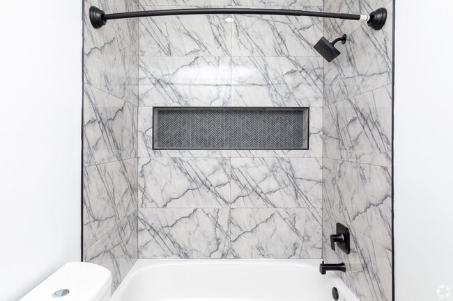 Redesigned bathrooms with chic tiles and custom shower niche