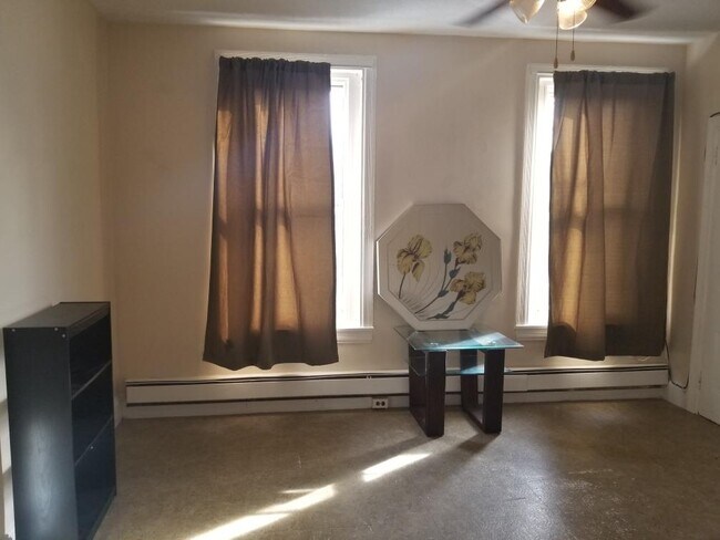 Bedroom with 2 windows facing street side.