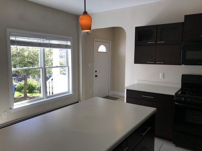 Kitchen looking out to the private yard and front door - 28 Munjoy St Townhome