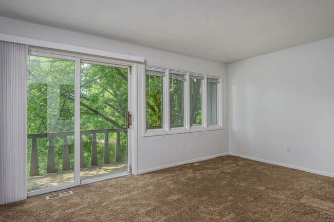 Living room, looking towards the patio - Cedar Ridge Apartments