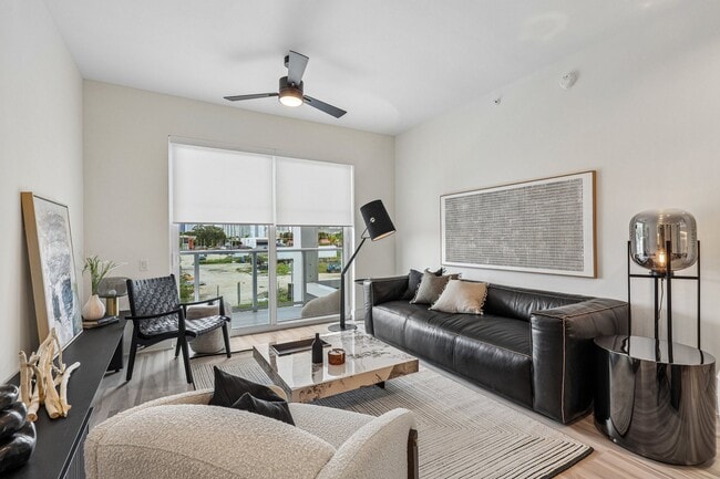 Stunning living room with hardwood-inspired flooring throughout - Blu Aventura