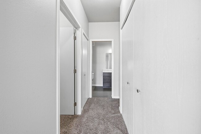 Step into North Highlands Apartments, where contemporary design meets comfort. This spacious hallway invites natural light, showcasing the modern finishes throughout. Explore your new home today—schedule a tour and see for yourself!