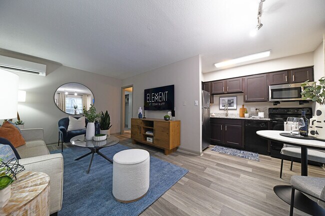 Experience the elegance and comfort of this stylish modern apartment, blending cozy living space with a sleek kitchen.
