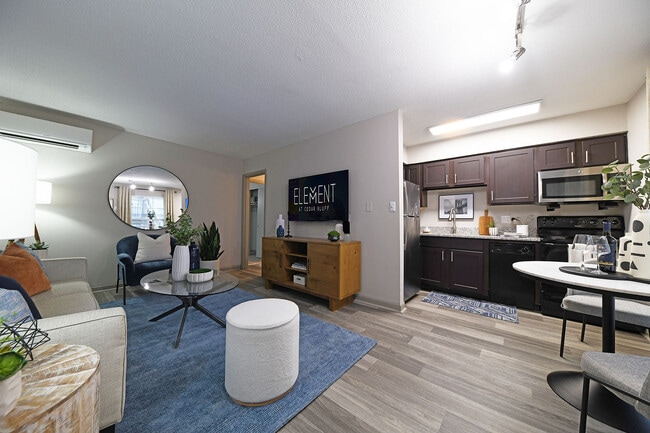 Experience the elegance and comfort of this stylish modern apartment, blending cozy living space with a sleek kitchen. - Element at Cedar Bluff