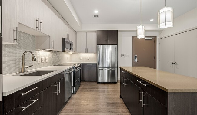 Large, modern kitchen with breakfast bar and designer cabinets