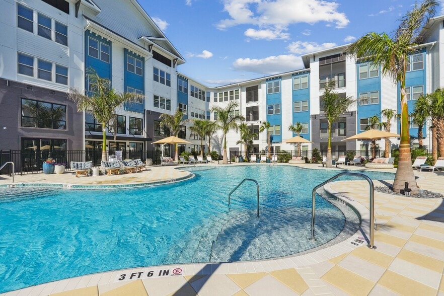 Resort-style pool with sun shelf, cabanas and grills for relaxing and entertaining close to home.