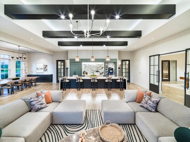 Bold beams, designer lighting, and curated textures set the tone for refined community spaces at Modera South Shore in Marshfield, MA.