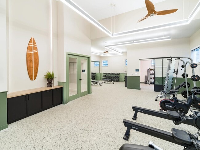 With airy ceilings and sleek coastal design, the fitness center at Modera South Shore features premium equipment—including rowers for a full-body workout.